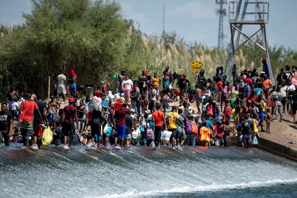 Haitian migrants cross the Rio Grande from Mexico into Texas.