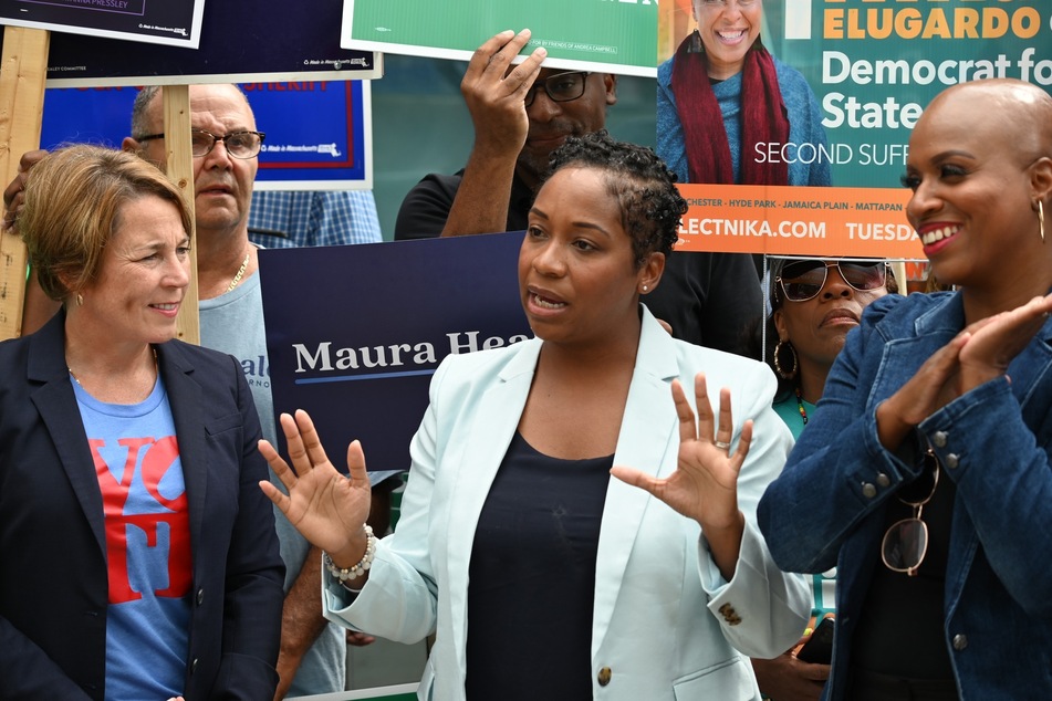 Democratic nominee for Massachusetts AG Andrea Campbell (c.) speaks at a campaign event alongside the state's Democratic nominee for governor Maura Healey (l.) and US Rep. Ayanna Pressley.