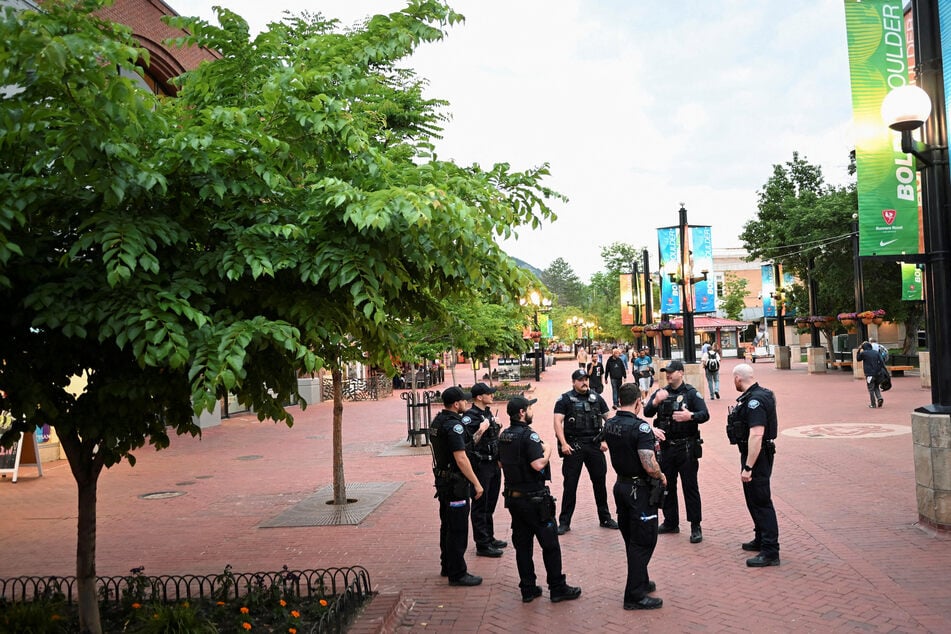 Police officers gather on Pearl Street in front of the Boulder County Courthouse, the scene of an attack that injured multiple people in Colorado.