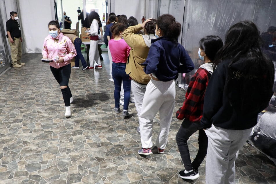 Unaccompanied migrant children and families are pictured at the US Customs and Border Patrol immigration processing center in Donna, Texas, in March 2021.