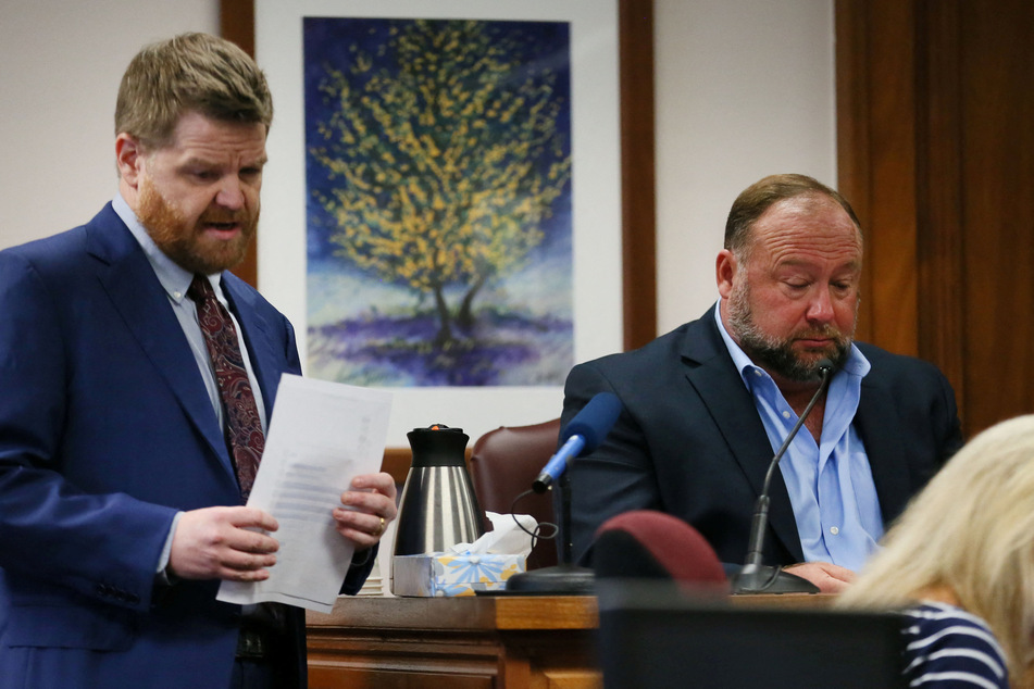 One of the plaintiffs' attorneys, Mark Bankston (l), informed Jones of a slip up by his legal team when the InfoWars host was on the stand on Wednesday.