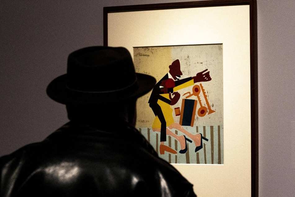 A visitor examines the Jitterbugs II painting by artist William H. Johnson on view at the Harlem Renaissance Exhibition.