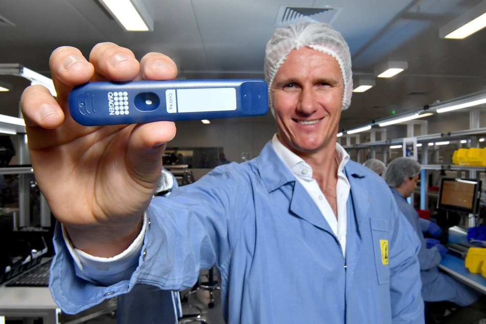 Ellume founder and CEO Sean Parsons holds one of the company's home test kits.