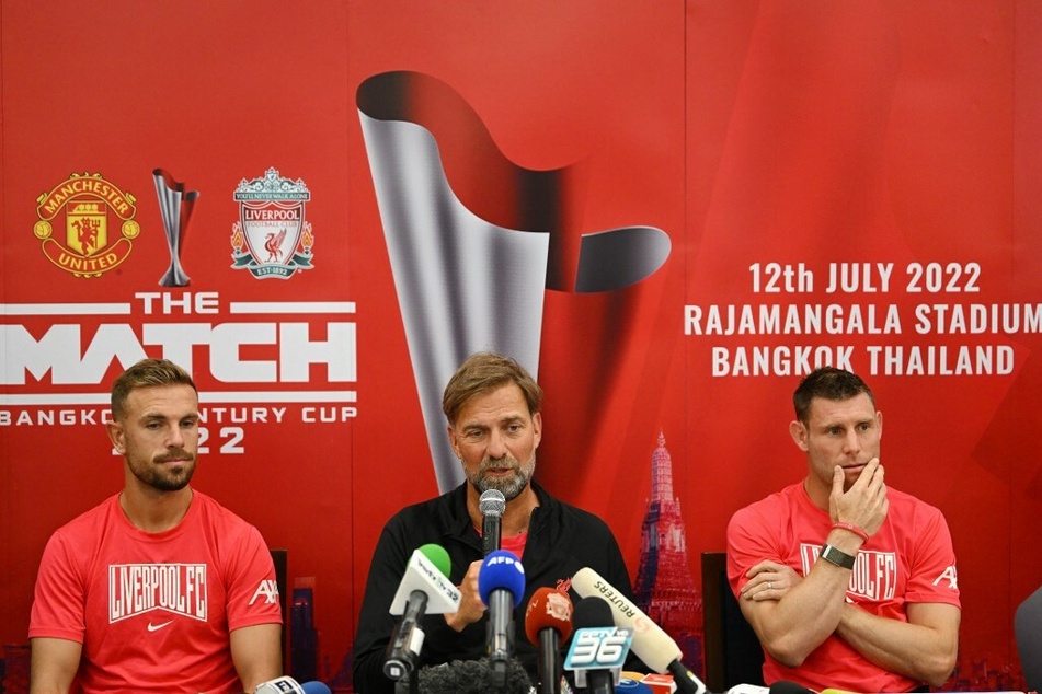 Jürgen Klopp (55, M.) mit seinen Spielern Jordan Henderson (32, l.) und James Milner (36) bei einer Pressekonferenz.