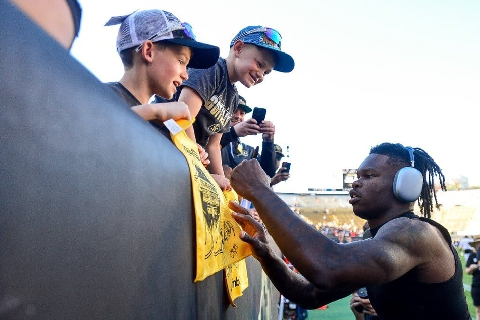 Coach Deion Sanders announced that the Buffaloes' star athlete Travis Hunter (r.) will be sidelined for three weeks due to an injury that resulted from an illegal hit.