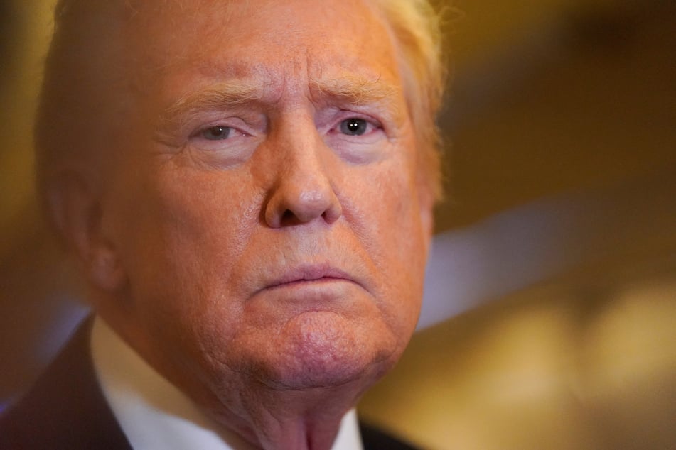 President Donald Trump speaks to members of the media as he flies to Washington aboard Air Force One on October 19, 2025.
