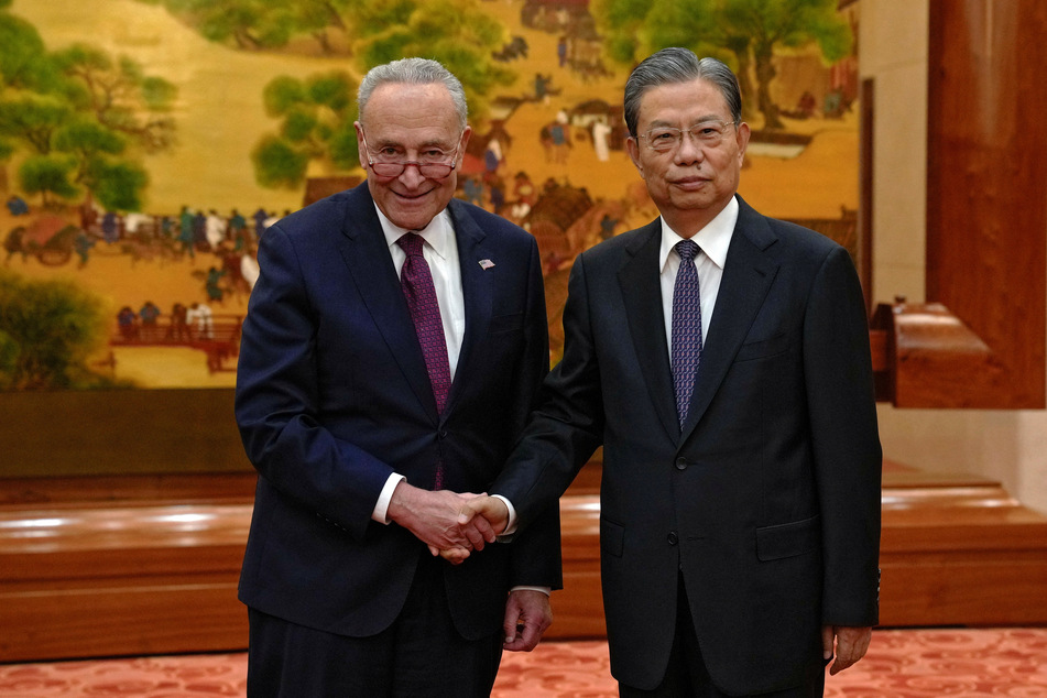 US Senate Majority Leader Chuck Schumer and Zhao Leji, chairman of China's National People's Congress, pose for a photograph before their bilateral meeting at the Great Hall of the People in Beijing on October 9, 2023.