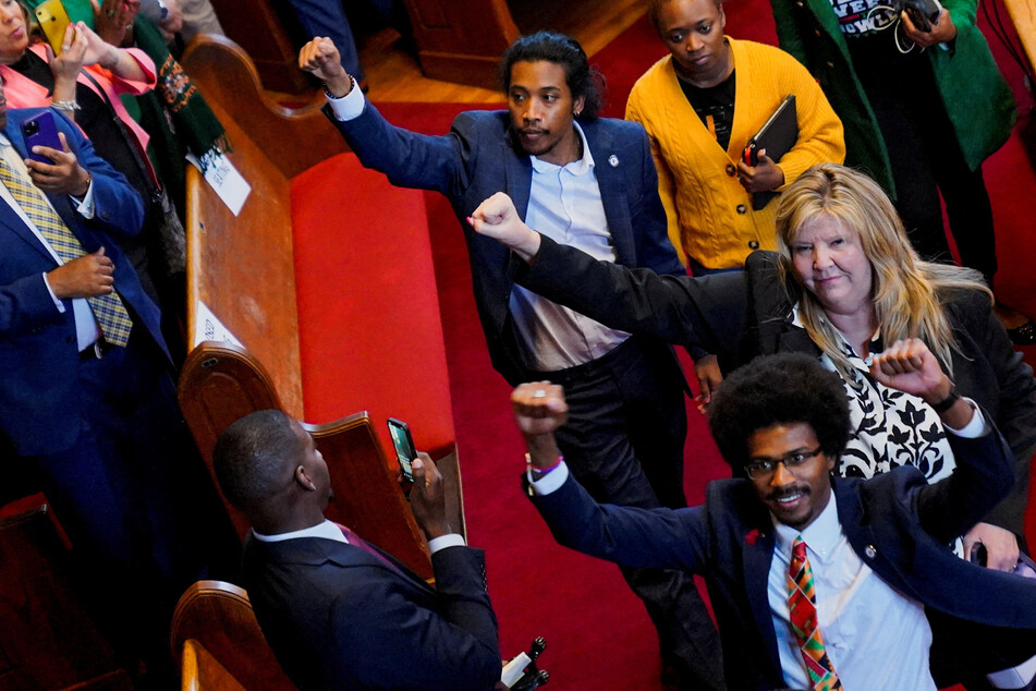 Tennessee state Reps. Justin Pearson, Gloria Johnson, and Justin Jones raise their fists after a rally with US Vice President Kamala Harris.