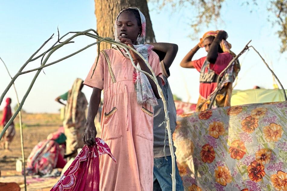 Displaced Sudanese people who fled El-Fasher after the city fell to the Rapid Support Forces, rest near the town of Tawila in Sudan's western Darfur region on October 28, 2025.