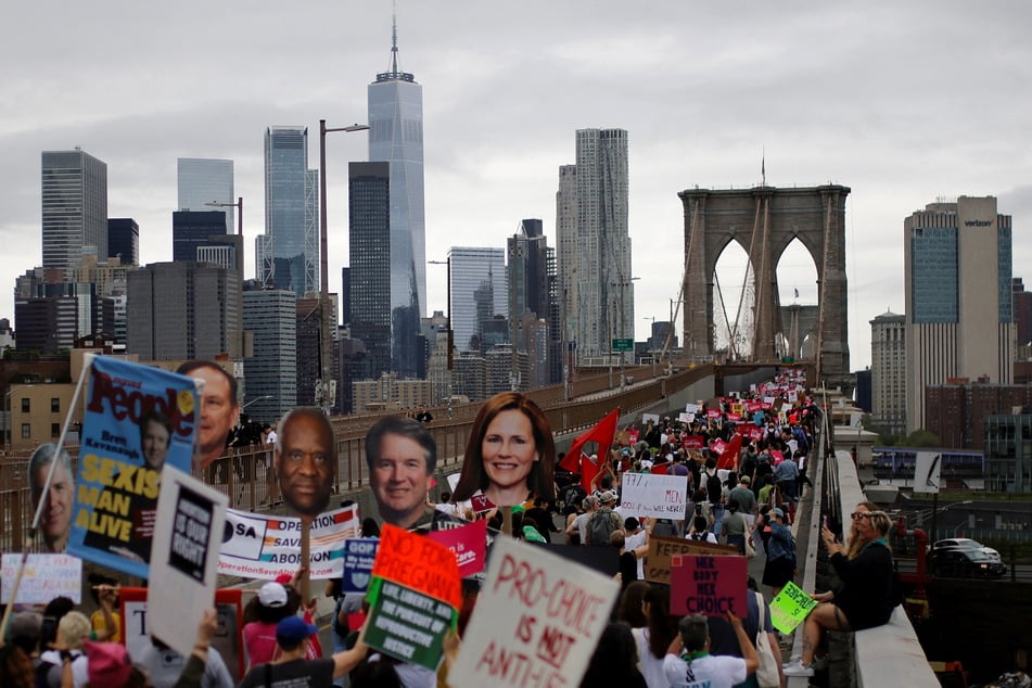 Thousands marching across the Brooklyn Bridge in support of women's rights.
