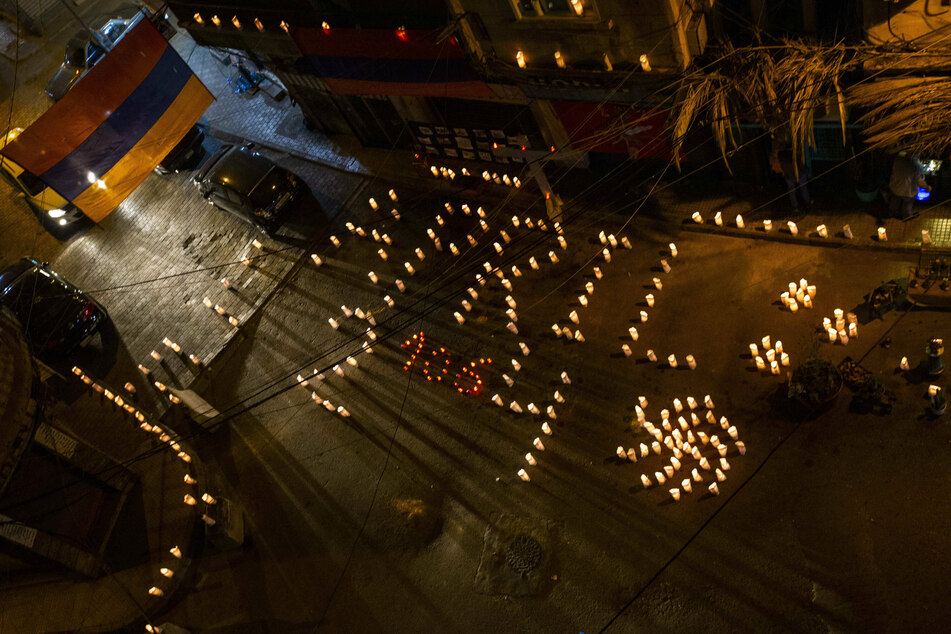 Candles, lit to commemorate the anniversary of the Armenian Genocide, burn on a street in Bourj Hammoud, an Armenian neighborhood, in Beirut, Lebanon.