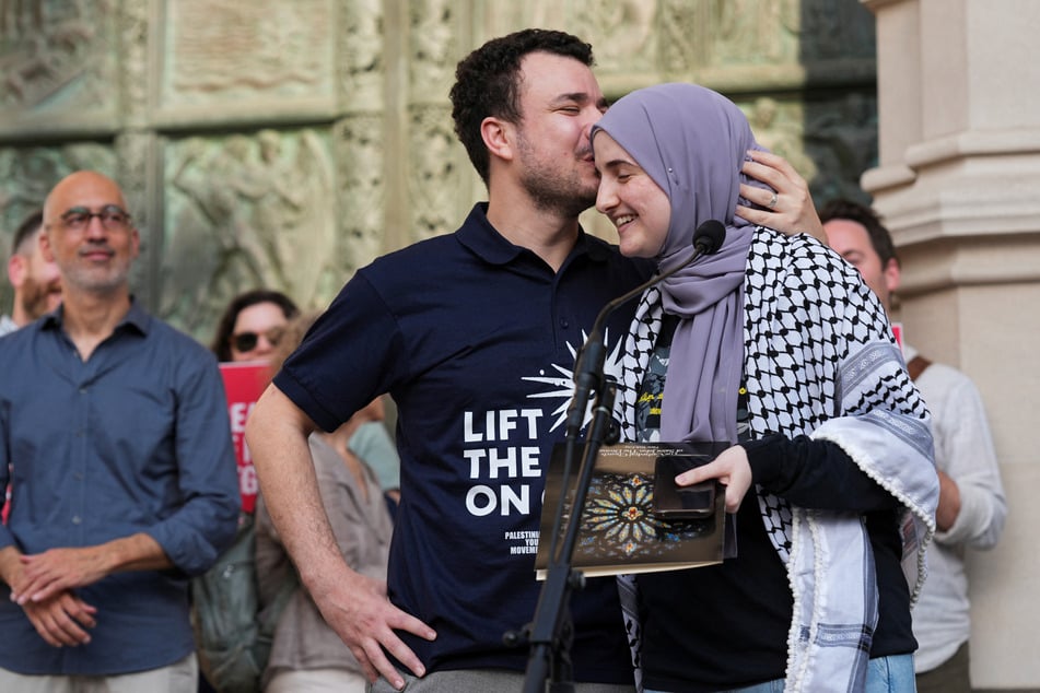 Mahmoud Khalil kisses his wife, Dr. Noor Abdalla, during a rally to welcome him home after his release from ICE custody.