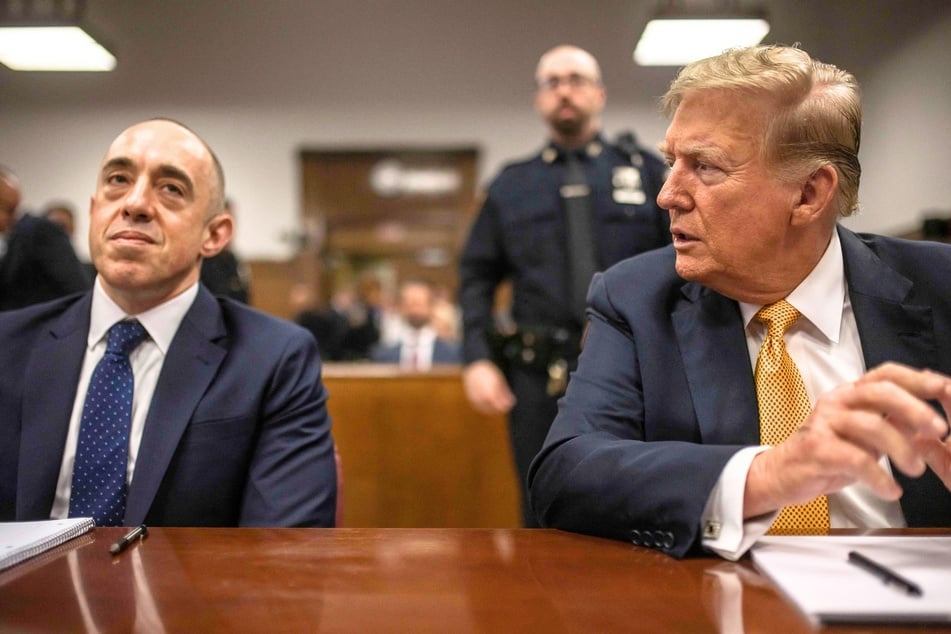 Donald Trump, sitting with attorney Emil Bove (l.), attends his trial for allegedly covering up hush money payments linked to extramarital affairs in New York City on May 21, 2024.