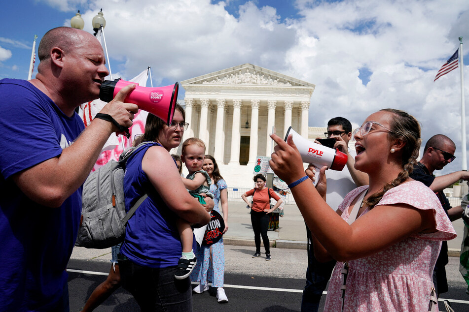 Abortion rights activists and counter-protesters demonstrate outside the US Supreme Court on the first anniversary of the court ruling in the Dobbs v. Women's Health Organization case.