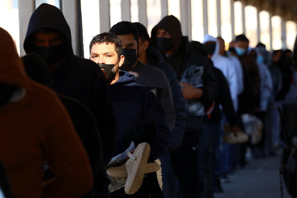 Migrants line up to leave the US for Mexico after being deported across the Paso del Norte international border bridge on January 23, 2025.