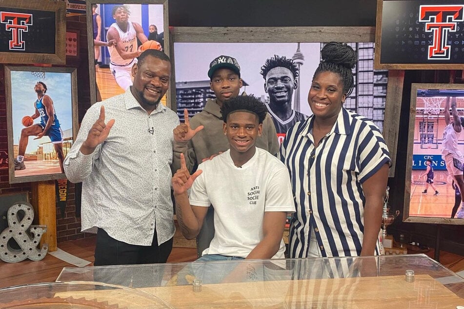 Elijah Fisher (c.) with his family after announcing he will reclassify his high school graduating year.