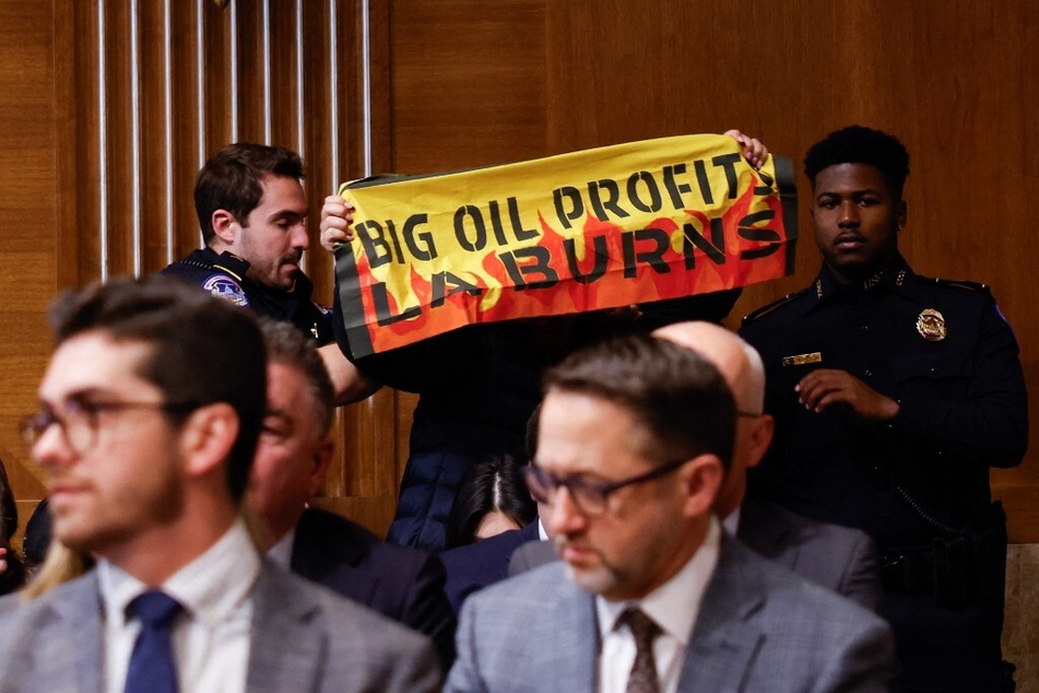 A protester is removed by US Capitol Police as Chris Wright testifies before a US Senate Energy and Natural Resources Committee hearing on January 15, 2025.