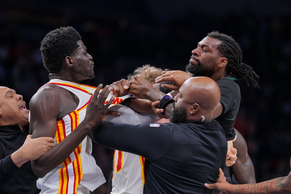 Atlanta Hawks forward Mouhamed Gueye and Minnesota Timberwolves center Naz Reid push each other in the fourth quarter at Target Center on February 9, 2026.