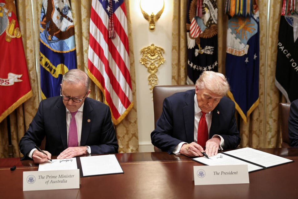 US President Donald Trump (r.) and Australia's Prime Minister Anthony Albanese sign an agreement on rare earth and critical minerals during a meeting at the White House on October 20, 2025.