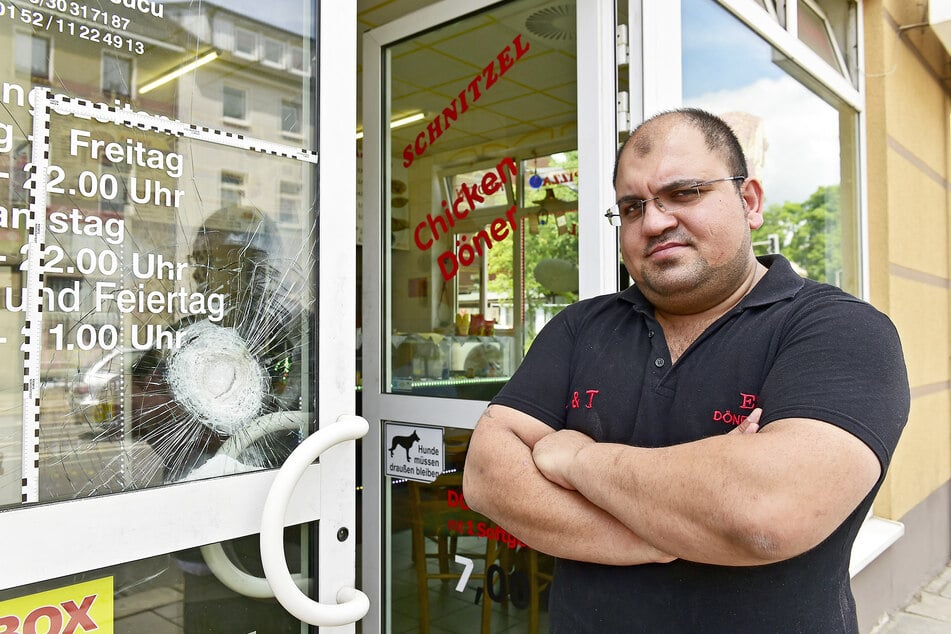 Dönerimbiss-Inhaber Erdal T. (34) vor seiner zersplitterten Eingangstür.