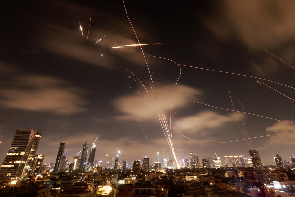 Israeli air defense systems are activated to intercept Iranian missiles over the Israeli city of Tel Aviv early on Wednesday.