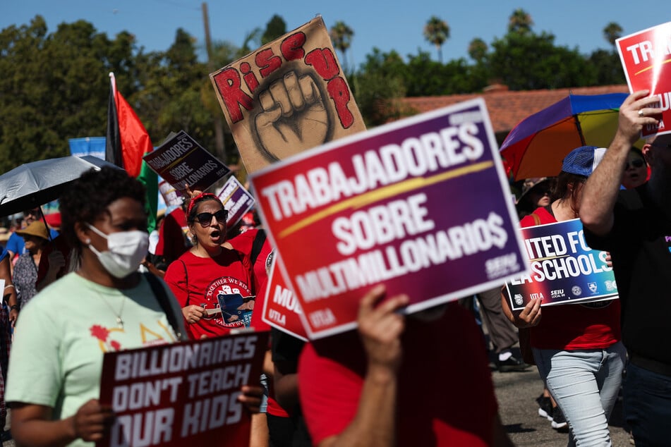 People march during the Los Angeles-Long Beach Harbor Labor Coalition 46th Annual Solidarity Parade and Picnic Rally in support of unions and organized labor in the Wilmington neighborhood of Los Angeles, California, on September 1, 2025.