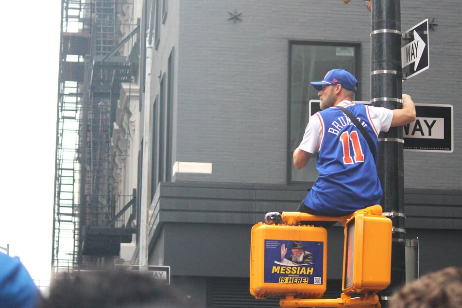 Fans hit the streets early to get a glimpse of the parade route in New York City on Thursday morning.