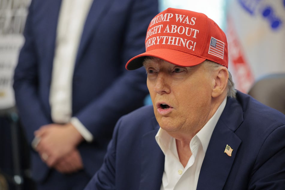President Donald Trump awkwardly tried to hide his hand from the cameras during a bizarre Oval Office appearance.