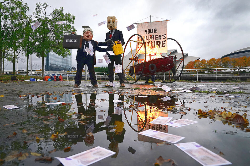 A protester dressed as British Prime Minister Boris Johnson on the banks of the River Clyde in Glasgow, close to the site of the upcoming Cop26 conference.