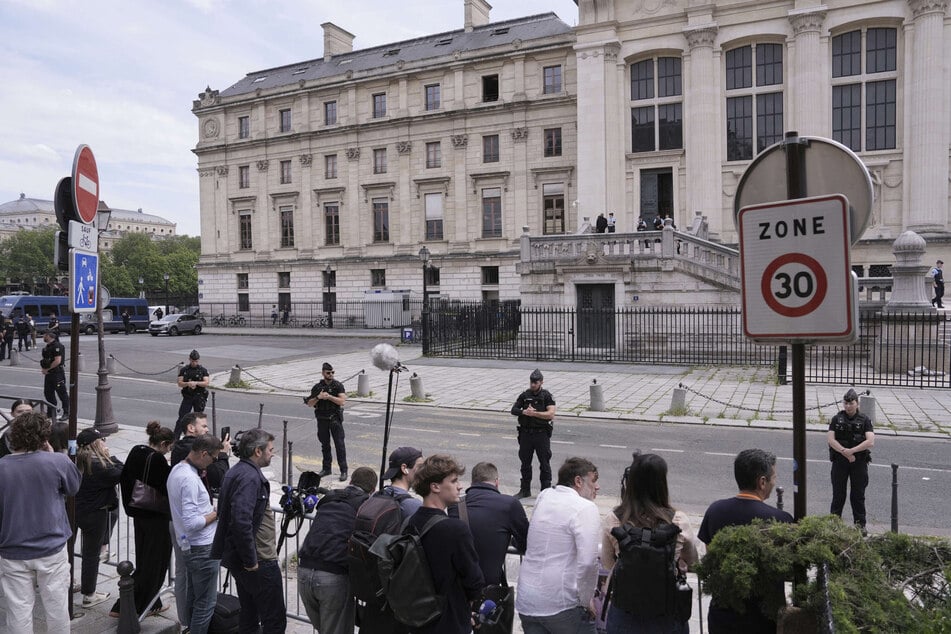 Police guards stand outside the Palace of Justice ahead of the trial for the jewelry heist from Kim Kardashian's Paris hotel room in 2016.
