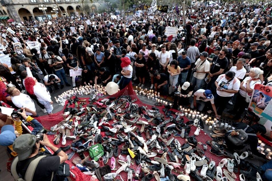 People place pairs of shoes during a vigil for those who lost their lives in the Izaguirre Ranch in Guadalajara, Jalisco state, Mexico, on March 15, 2025.