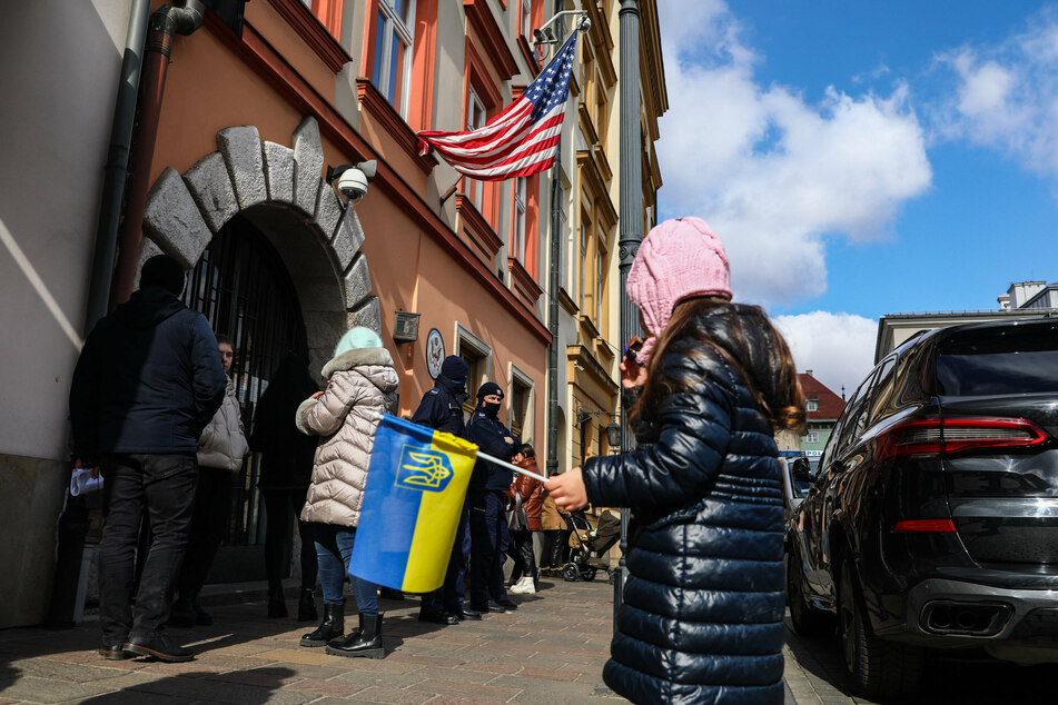 Ukrainian citizens and supporters attend a demonstration of solidarity with Ukraine in front of the US Consulate General in Cracow, Poland.