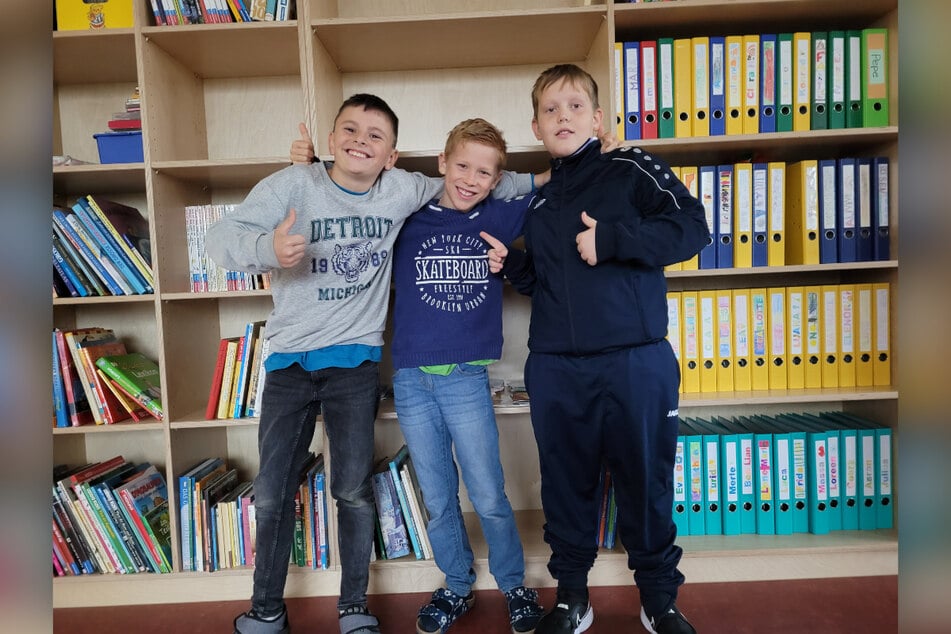 Anton (11, v.l.), Tim (9) und Liam (9) haben TAG24 stolz durch ihre neue Schule geführt.