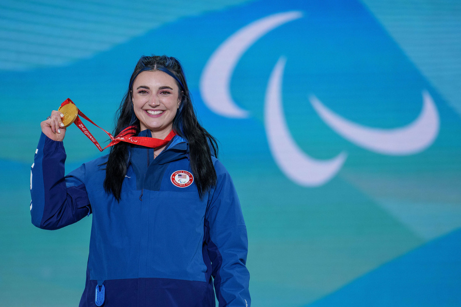 Brenna Huckaby celebrates on the podium after winning the gold medal in the Women Banked Slalom.