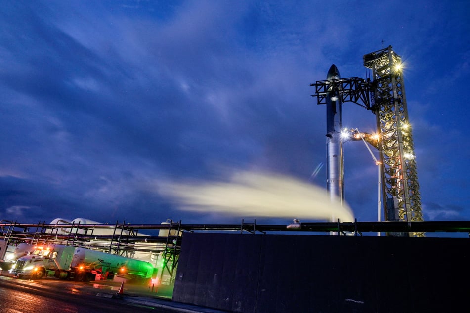 Fuel trucks carrying liquid nitrogen line up before sunrise as preparations to launch a SpaceX Starship spacecraft continue, at the company's complex in Texas on August 25, 2025.