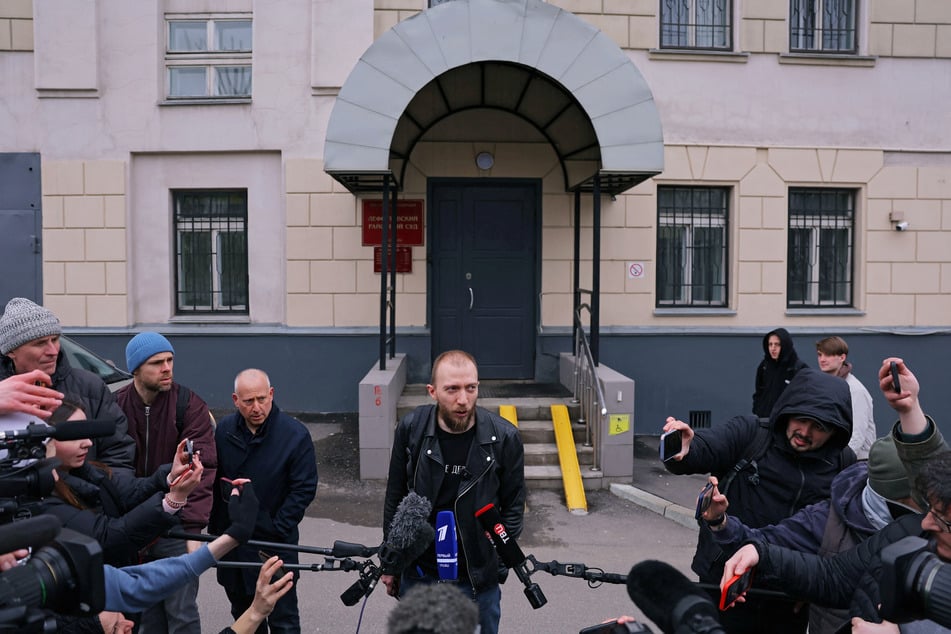 Daniil Berman (c.), one of Evan Gershkovich's lawyers, speaks to the journalists outside a court building in Moscow last week.
