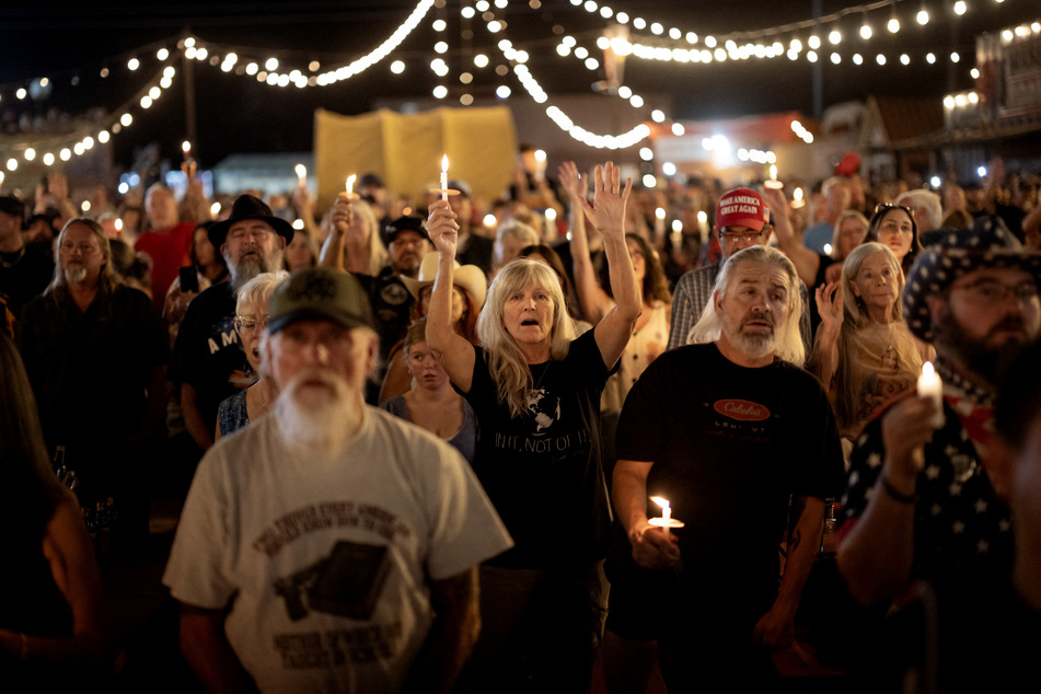 People attend a vigil for Charlie Kirk at Western Trails Ranch on Saturday in Morristown, Arizona. Kirk, the CEO and co-founder of Turning Point USA, was shot and killed on Wednesday in Utah.