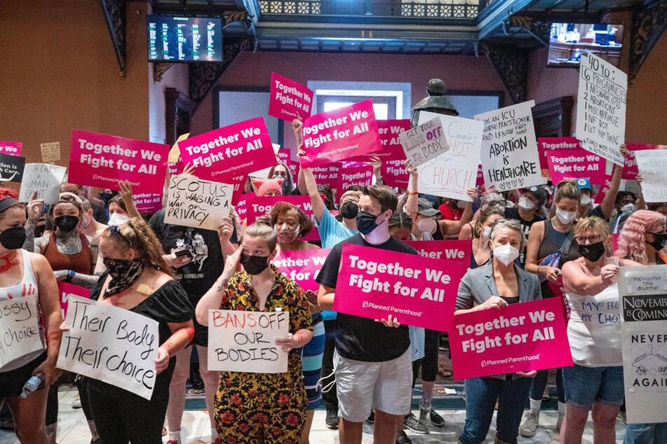 Protesters rally for reproductive justice inside the South Carolina Statehouse.