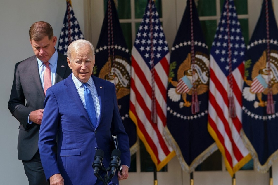 President Joe Biden (r.), joined by Secretary of Labor Marty Walsh, arrives to speak about the railway labor agreement in the White House Rose Garden on September 15, 2022.