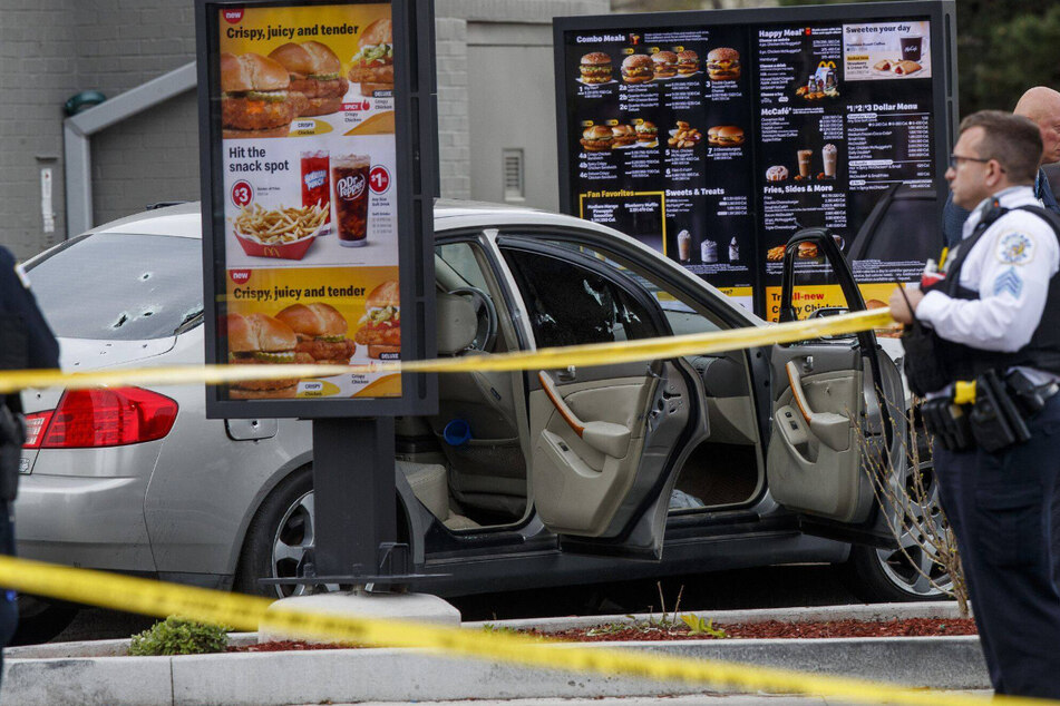 Photos from the scene showed bullet holes in the back windshield of the victims' car in the McDonald's drive-through.