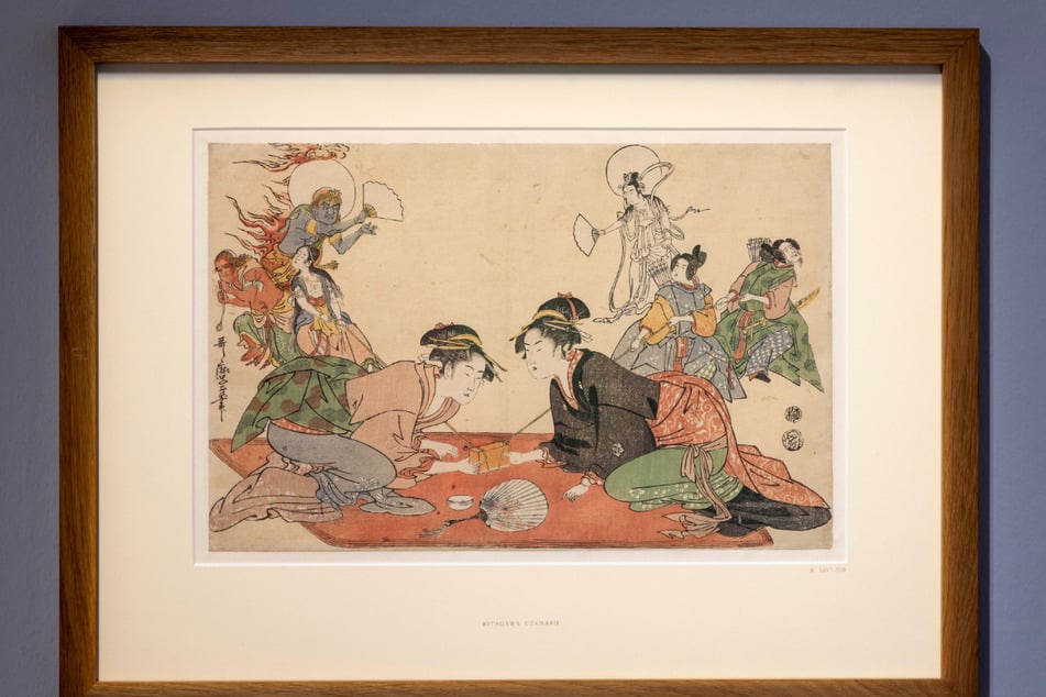 "Kraftprobe im Takashimaya Teehaus mit Hilfe von Shinto- und Buddhistischen Gottheiten" (um 1802–04) von Kitagawa Utamaro.