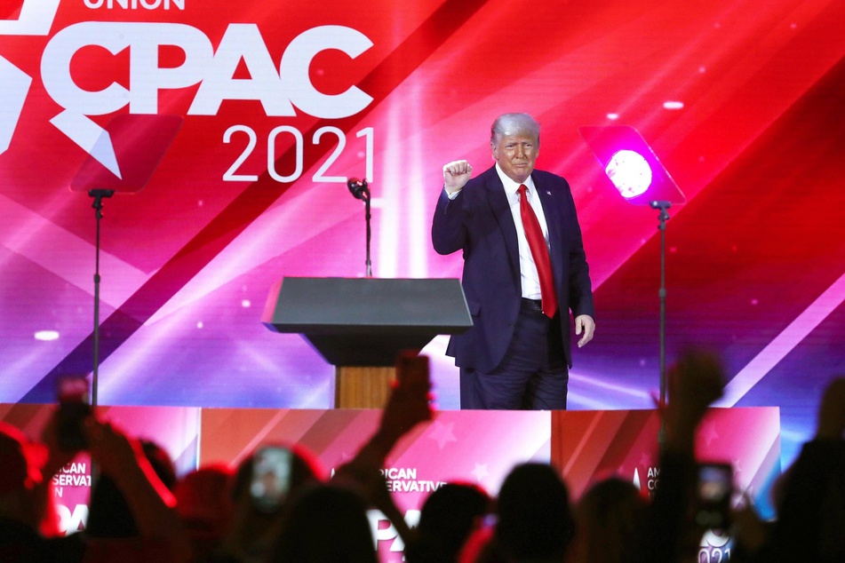 The audience cheers as former President Donald Trump finishes his speech during CPAC at the Hyatt Regency in Orlando, Florida