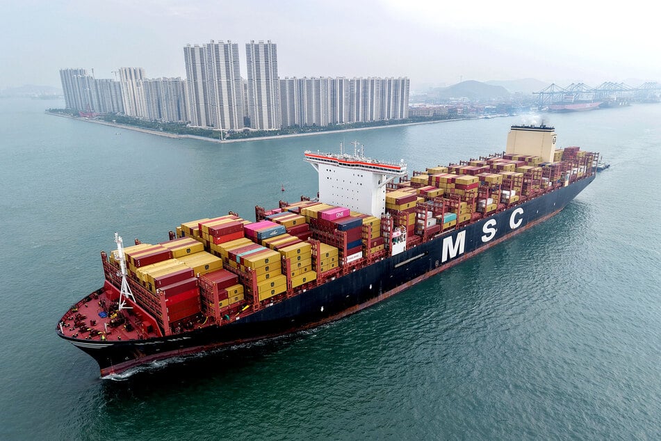 A container ship moving towards its berth at the container terminal of the port in Qingdao, in China's eastern Shandong province.