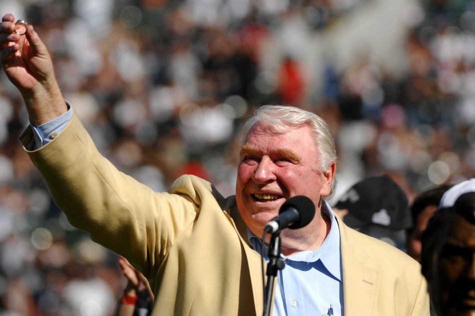 John Madden showing his Pro Football Hall of Fame ring to the Oakland Raiders crowd during a pregame ceremony.