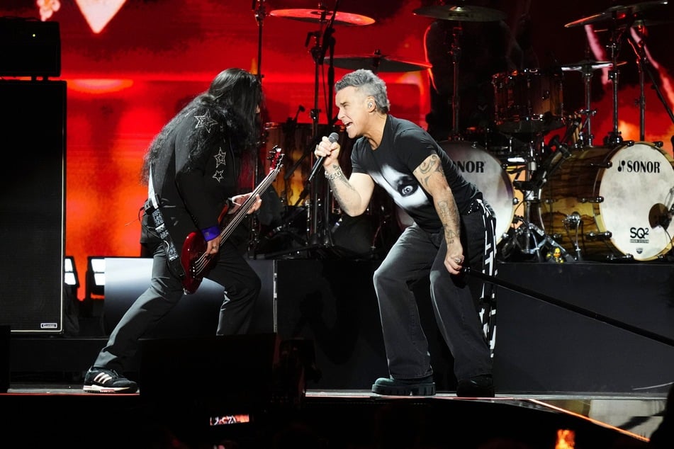 Sänger Robbie Williams (52, r.) performte auf der Bühne mit Mitgliedern von Ozzys Band.