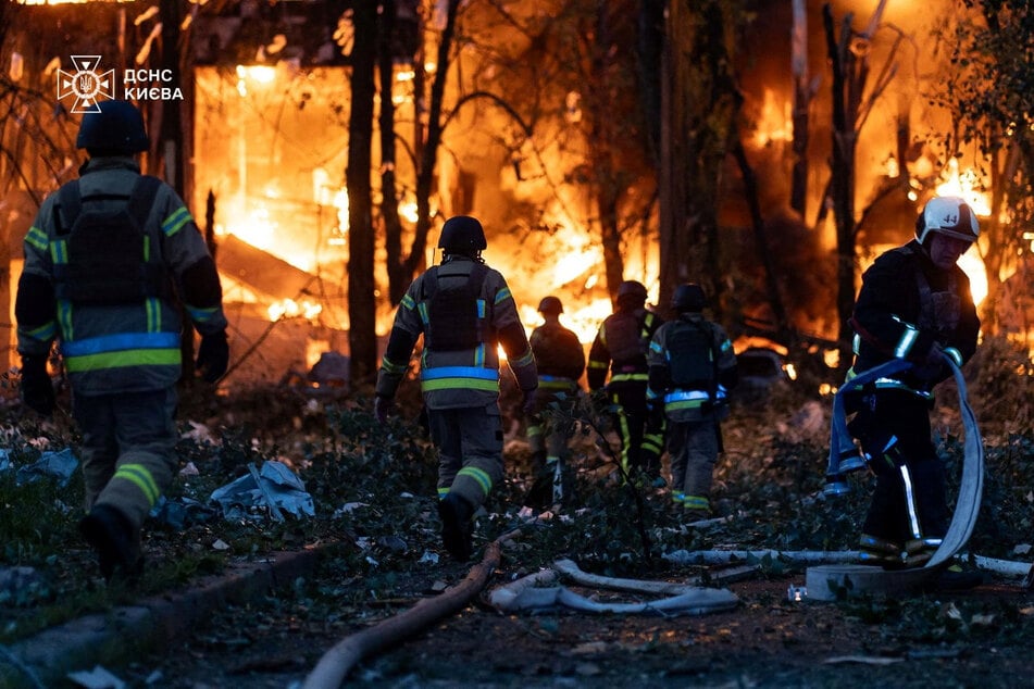 Firefighters work at the site of the Russian drone and missile strike in Kyiv, Ukraine, on July 4, 2025.