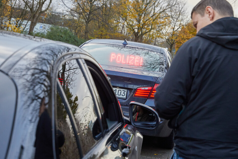 Ein Beamter der Polizei Hamburg überprüft ein Fahrzeug. (Symbolbild)