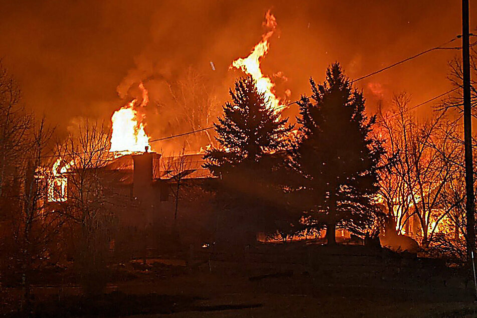 A home burns after a fast moving wildfire swept through the area. The fire that tore through parts of Boulder County may have destroyed up to 1,000 homes.