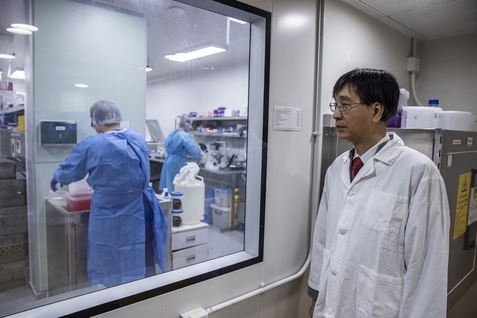 Microbiologist Yuen Kwok-yung (r.) stands outside a Physical Containment Level 3 Facility at Queen Mary Hospital in Hong Kong.