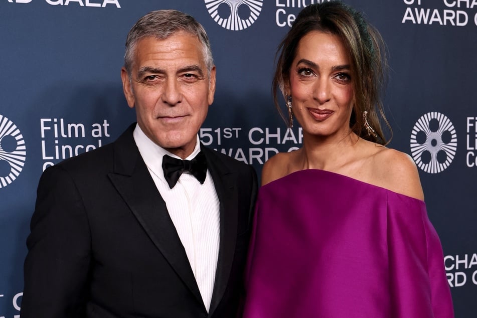 George and Amal Clooney (r) addressed the mayor of Brignoles after fleeing their home in France due to wildfires.